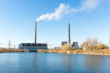 Obraz premium Photo of a thermal power plant and ventilation pipes from far away. The technology of power generation.