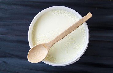 Yogurt in the bucket, yogurt fermented, yoghurt with spoon to take

