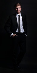 Full-length portrait of business man   isolated  on black backgr