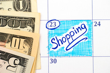 Reminder Shopping in calendar with dollar banknotes