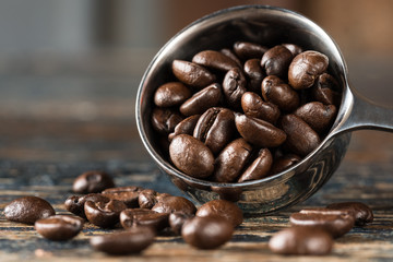 Whole Coffee Beans Spilled from a Coffee Scoop
