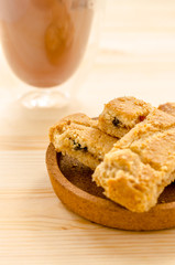Apple strudel crispy pies and ice coffee on wood background.