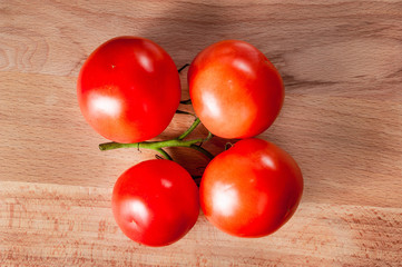 Branch of tomatoes cutting board..