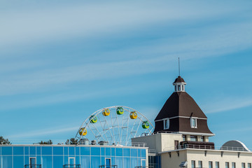 Obraz premium Ferris wheel, big wheel, Fragment of grand Ferris Wheel . modern buildings. Glass building. Hotel view