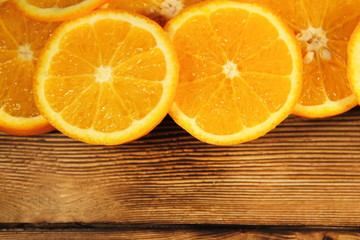 Sliced oranges on wooden table with copy space