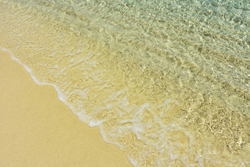 Fototapeta na wymiar Clear sea water waves on the beach of Lipe island,southern Thailand.