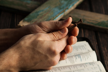 Crown of thorns with hands folded in prayer
