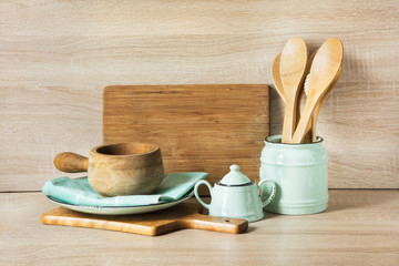 Wooden rustic and vintage crockery, tableware, utensils and stuff on wooden table-top. Kitchen still life as background for design. Image with copy space.