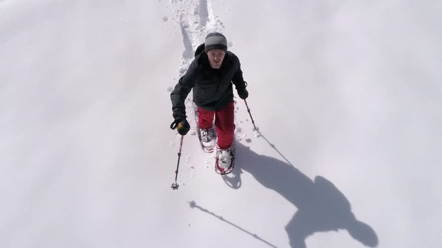Isolated Overhead Drone Shot of Snowshoeing Adventure in Deep Powder on Sunny Day