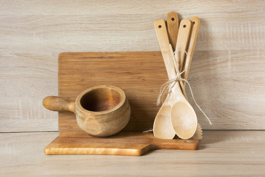 Wooden rustic and vintage crockery, tableware, utensils and stuff on wooden table-top. Kitchen still life as background for design. Image with copy space.
