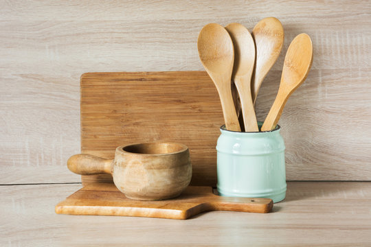 Wooden rustic and vintage crockery, tableware, utensils and stuff on wooden table-top. Kitchen still life as background for design. Image with copy space.