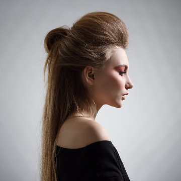 Portrait of woman with stylish hairstyle in profile