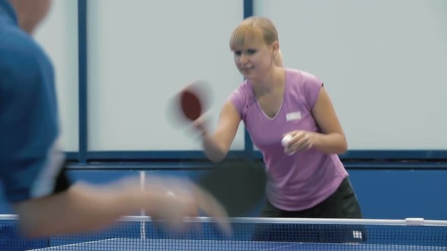 Close-up: man and woman playing a ping-pong
