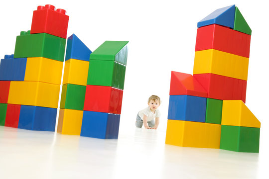 Baby Builder With Huge NO Brand Colourful  Building Blocks, Needing A New Place, House Or Real Estate, Isolated On White