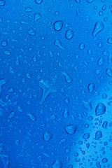 Rain drops on metal blue surface