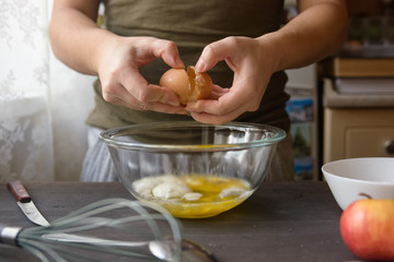 Woman hands breaking egg