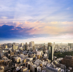 Cityscape of Tokyo, city aerial skyscraper view of office building and downtown and street of  minato in tokyo with sunset / sun rise  background with light beam pass cloud, tokyo. Japan, Asia