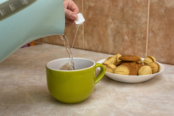 Teapot and cup of tea at home