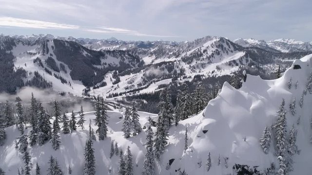 Mountain Peak Aerial Reveal of Stevens Pass Winter Ski Resort in Ultra Real 60p 4K