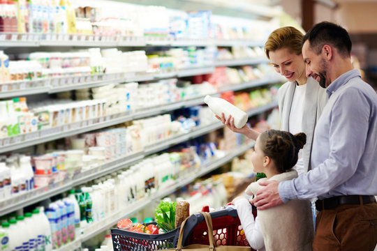 Modern family choosing dairy products in supermarket