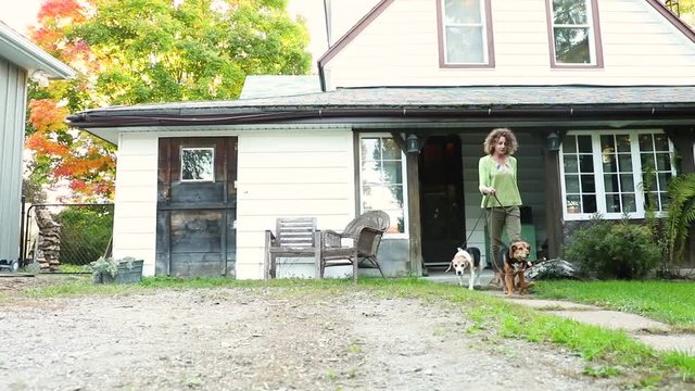 Woman Walking The Dogs Out Of House, Slow Motion