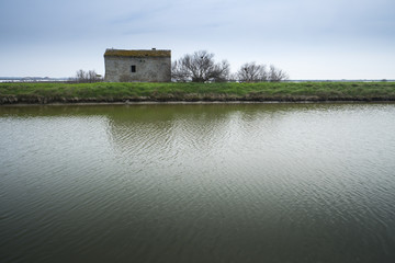 Fototapeta na wymiar Ancient fishing house in the lagoon of Comacchio, Italy
