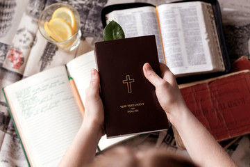 Girl holding a Bible. Сoncept for faith, spirituality and religion. Young woman reading a Bible.