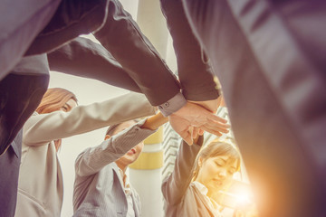 Success Teamwork Concept, Business people team joining hands outside office city background
