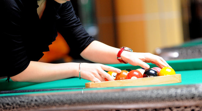 Close-up shot of a woman playing snooker