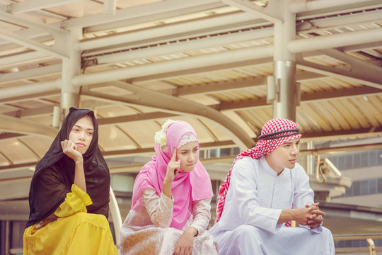 Close Up Of Young Arab Middle Eastern Man And Woman Sitting And Thinking At City.