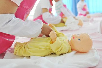 newborn care exercise on infant dummy.