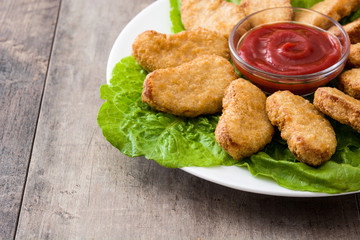 Fried chicken nuggets on wooden table
