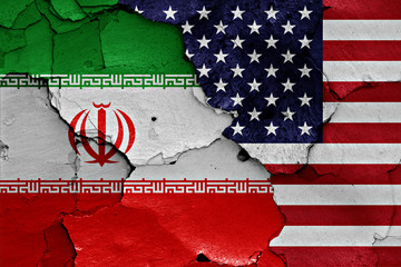 flags of Iran and USA painted on cracked wall