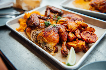 Mexican roadside chicken BBQ with rice potatoes and lime.