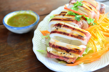 Grilled squid with spicy sauce - selective focus