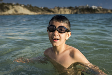 boy with glasses for swimming in the sea