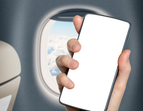 hand with blank mobile phone in airplane or jet interior