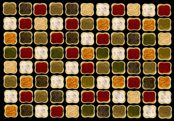 Bright spices in square green ceramic bowls on black background contrasting picture