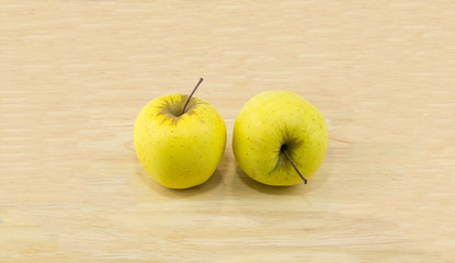 Two juicy yellow apple golden on a wooden table a perfect snack