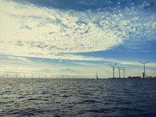 Wind turbines power generator farm along coast sea