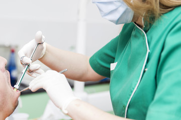 Female dentist provides dental anesthesia to patient