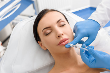 Calm woman receiving cosmetic procedure