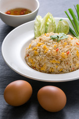 Fried rice with spicy sauce on stone background