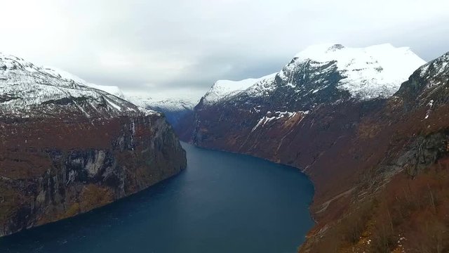 Aerial Norway cliff in aurland. Snow mountain and blue water