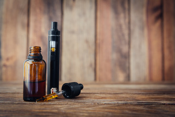 Stock Photo - E-cigarette or vaping device on wooden surface, natural light