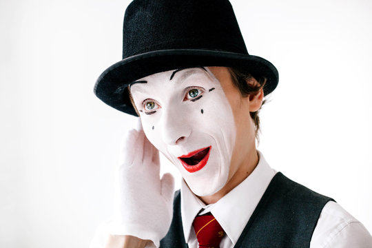 Funny curious mime hears something