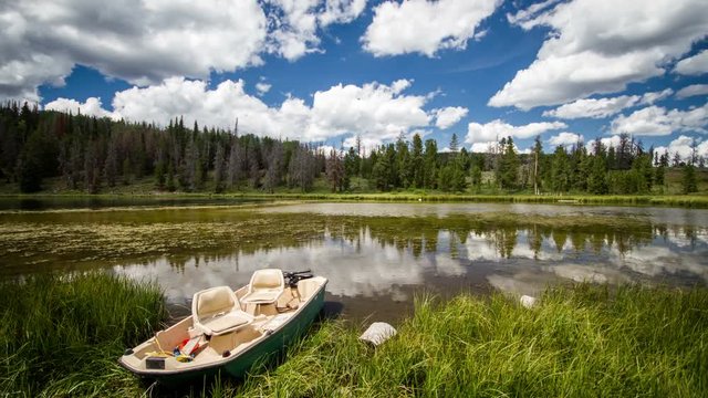 Time-lapse video in the Uinta Mountains with a boat  on the edge of a lake.