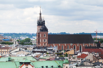 Naklejka premium Aerial view of the Church of St. Mary in Krakow. Basilica Mariacka. Dramatic sky. Krakow. Poland. Panorama of city