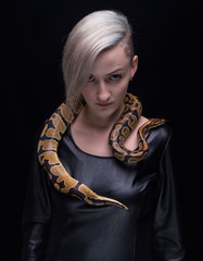 Woman in leather dress and royal python