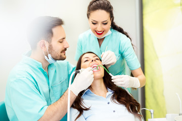 A dentist with assistant working on a patient